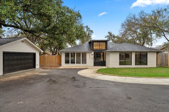 view of front of home featuring a front yard and a garage