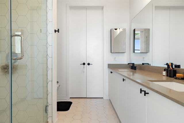 bathroom featuring tile patterned floors, vanity, and a shower with shower door