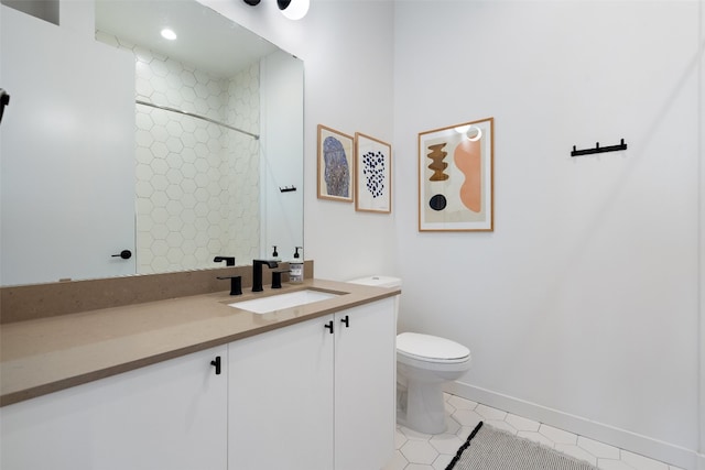 bathroom featuring toilet, a tile shower, vanity, and tile patterned floors