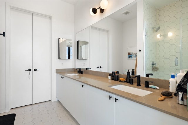 bathroom featuring tile patterned floors, vanity, and walk in shower