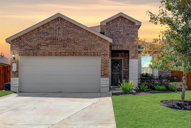 view of front facade with a garage and a yard