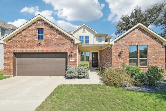 view of front of property with an attached garage, brick siding, concrete driveway, a front lawn, and board and batten siding