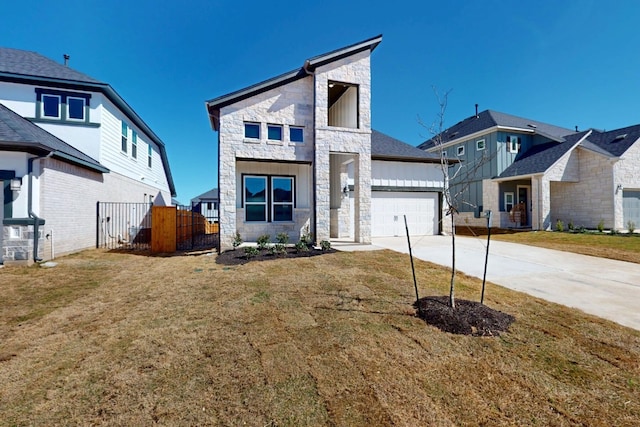 view of front of property featuring an attached garage, fence, stone siding, and driveway