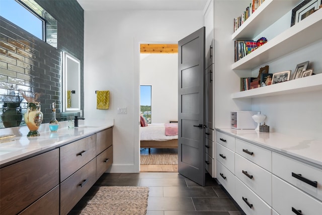 bathroom featuring vanity and tasteful backsplash