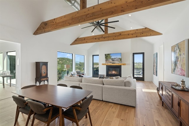 dining area featuring beamed ceiling, ceiling fan, light hardwood / wood-style flooring, and high vaulted ceiling