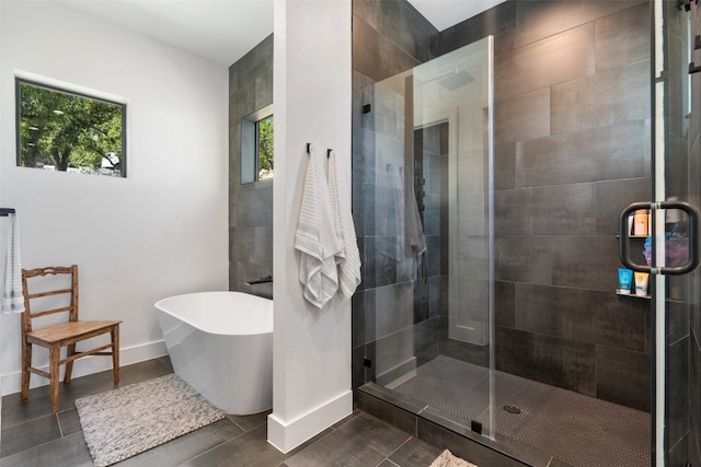 bathroom with independent shower and bath and tile patterned flooring