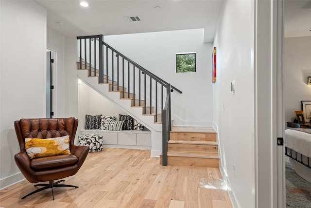 stairs with hardwood / wood-style flooring