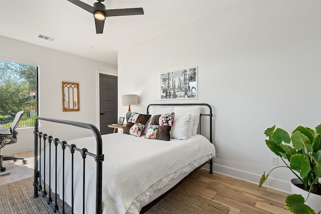 bedroom with ceiling fan and hardwood / wood-style flooring