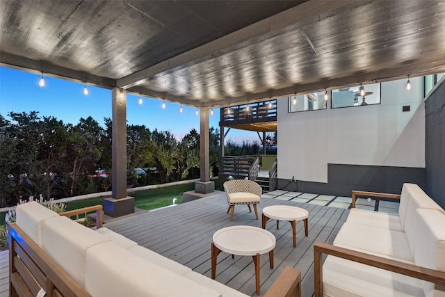 wooden terrace with an outdoor living space