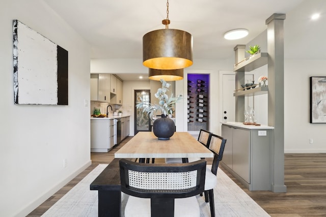 dining room with wood-type flooring and sink