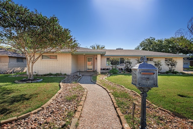 ranch-style home featuring a front yard