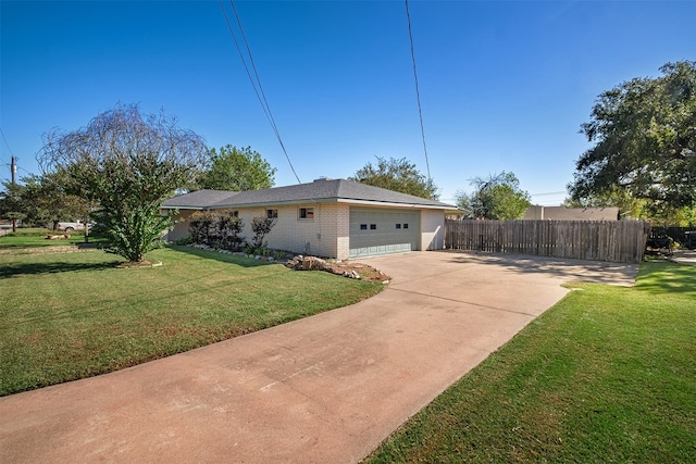 view of side of property with a lawn and a garage