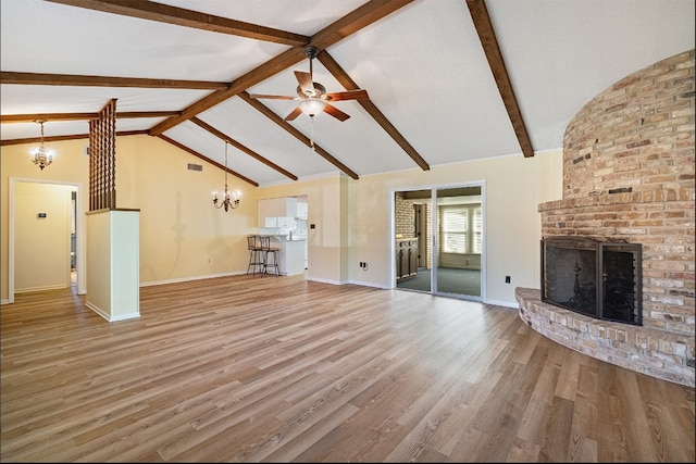 unfurnished living room featuring high vaulted ceiling, a fireplace, beamed ceiling, ceiling fan, and hardwood / wood-style floors