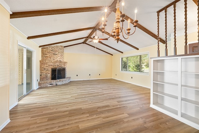 unfurnished living room with wood-type flooring, a fireplace, lofted ceiling with beams, and an inviting chandelier