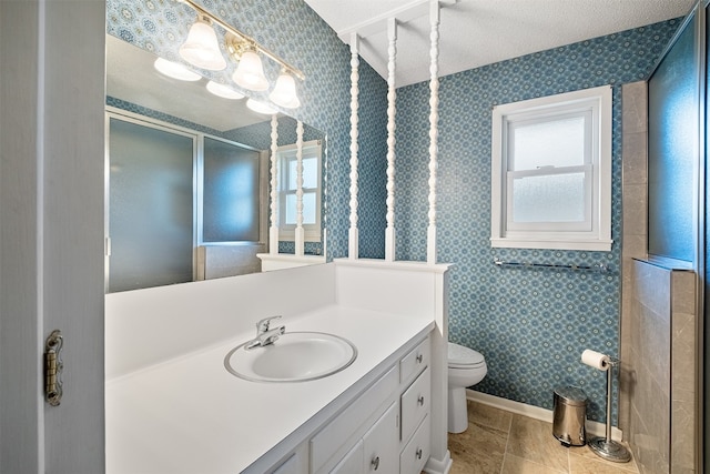 bathroom featuring vanity, plenty of natural light, toilet, and tile patterned floors