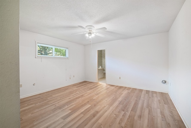 empty room featuring light hardwood / wood-style floors, ceiling fan, and a textured ceiling