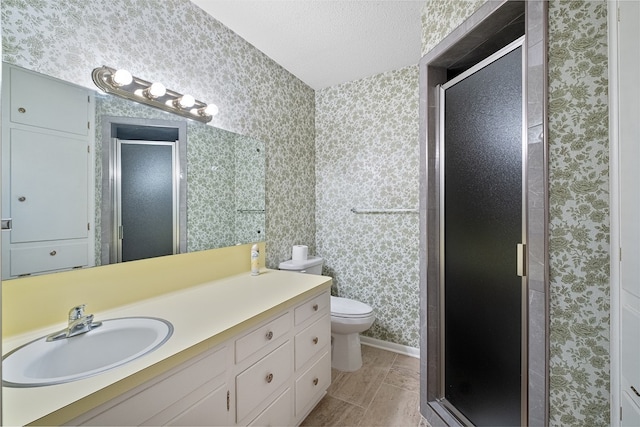 bathroom with walk in shower, vanity, toilet, and a textured ceiling