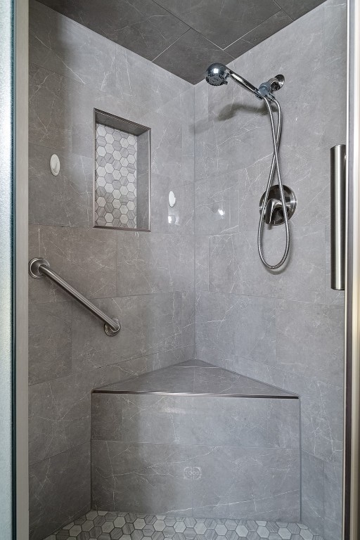 bathroom with a tile shower