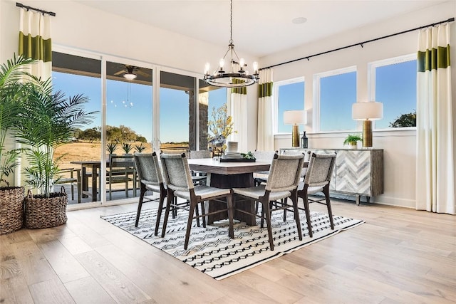 sunroom / solarium featuring a chandelier