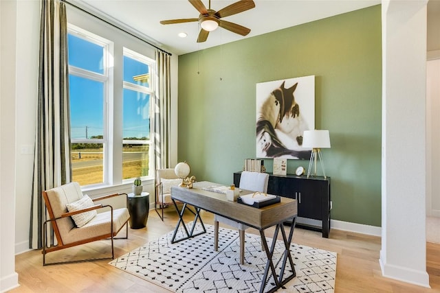 office space featuring ceiling fan and light hardwood / wood-style floors