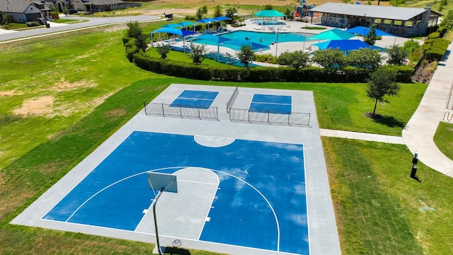 view of sport court with a lawn