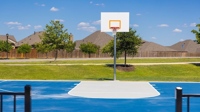 view of sport court featuring a lawn