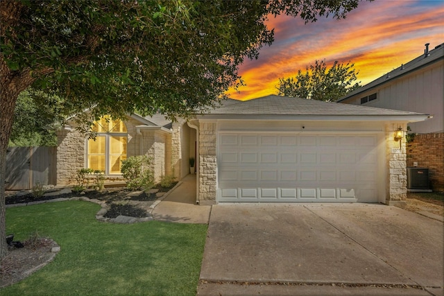 view of front of property with central AC unit and a garage