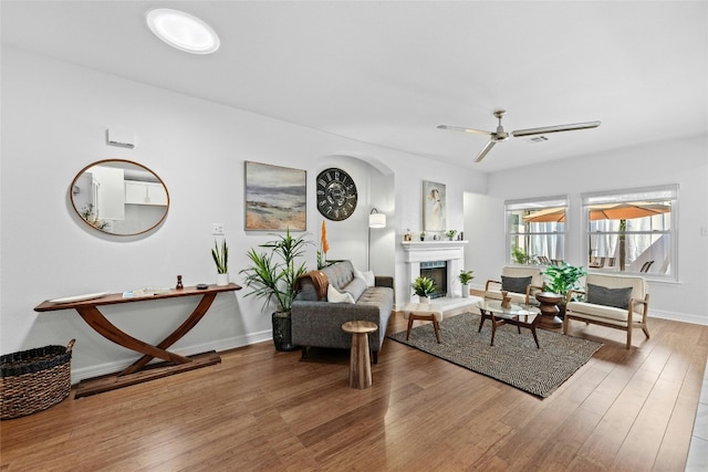 living room with ceiling fan and wood-type flooring