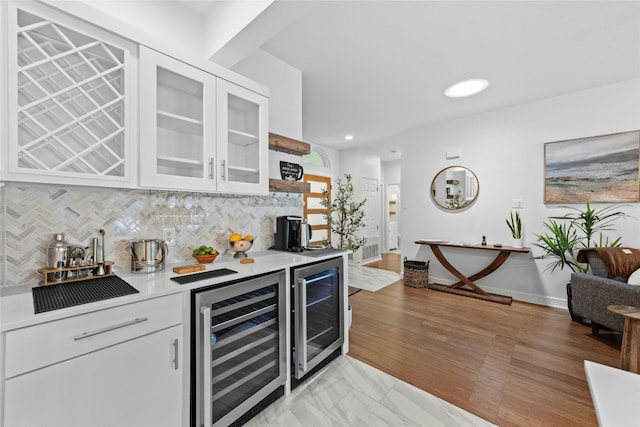 bar featuring tasteful backsplash, wine cooler, and white cabinets