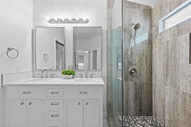 bathroom featuring vanity and tiled shower