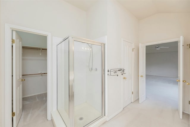 bathroom featuring walk in shower, lofted ceiling, and ceiling fan