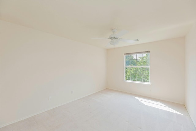 empty room featuring light carpet and ceiling fan