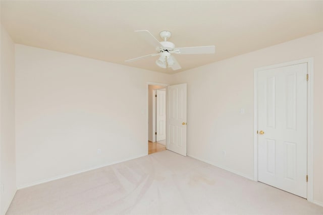 carpeted empty room featuring ceiling fan