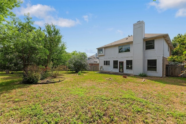 back of house featuring a yard