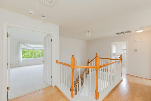 hallway with light hardwood / wood-style flooring