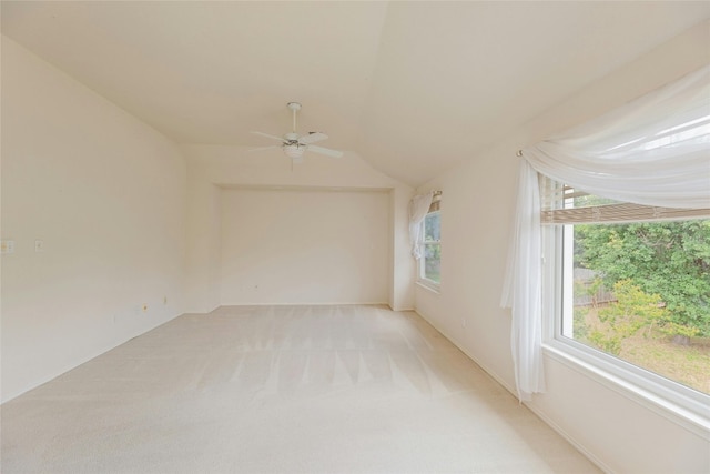 unfurnished room with vaulted ceiling, ceiling fan, and light colored carpet