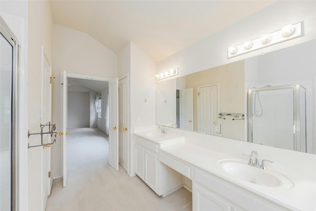 bathroom featuring lofted ceiling, a shower with door, and vanity