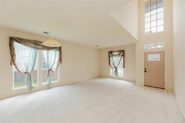 entryway featuring a healthy amount of sunlight and light colored carpet