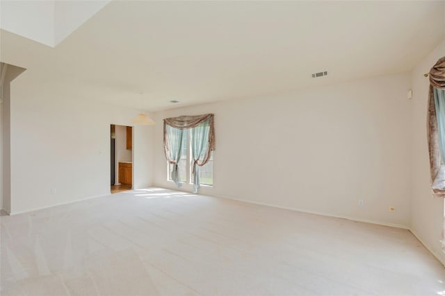 unfurnished room featuring light colored carpet