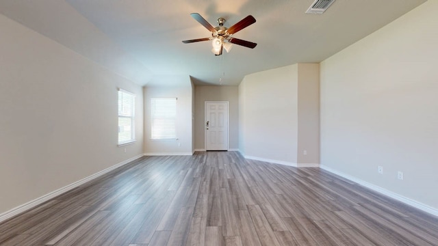 spare room featuring light hardwood / wood-style flooring and ceiling fan