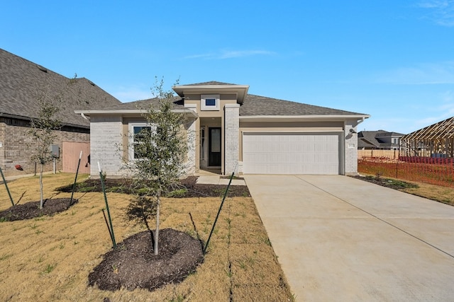 202 Grand Canyon Way, Kyle, TX 78640 - view of front of home featuring brick siding, fence, driveway, and an attached garage