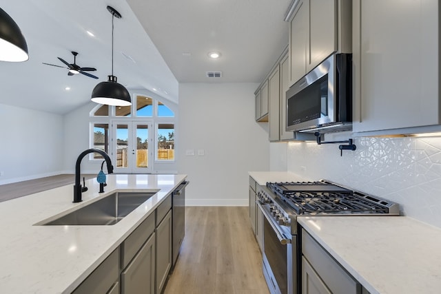 202 Grand Canyon Way, Kyle, TX 78640 - kitchen featuring visible vents, stainless steel appliances, gray cabinets, and a sink