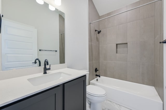 full bathroom with vanity, toilet, and tiled shower / bath