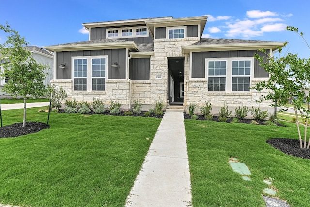 8508 Dongan Dr, Austin, TX 78744 - prairie-style house with board and batten siding, stone siding, a front lawn, and a shingled roof