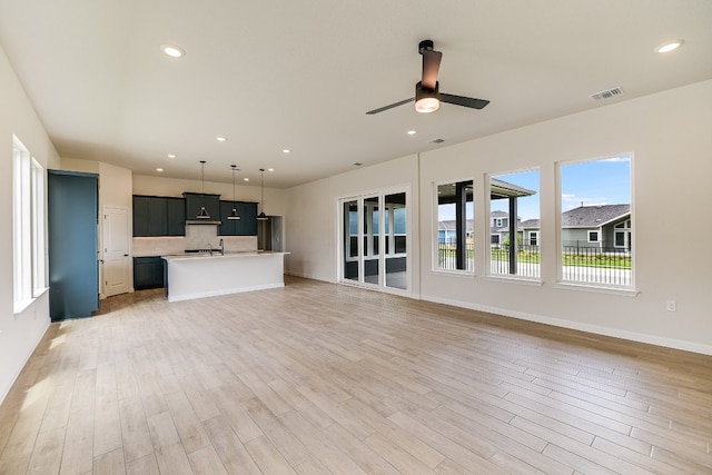 8508 Dongan Dr, Austin, TX 78744 - unfurnished living room featuring light wood finished floors, a ceiling fan, and recessed lighting