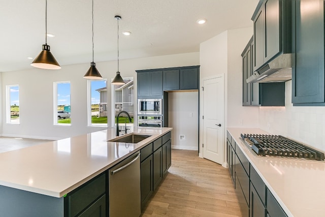 8508 Dongan Dr, Austin, TX 78744 - kitchen with appliances with stainless steel finishes, light wood finished floors, tasteful backsplash, light countertops, and recessed lighting