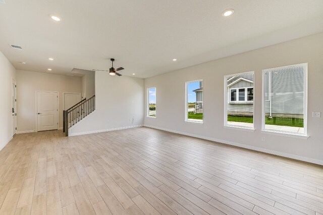 8508 Dongan Dr, Austin, TX 78744 - unfurnished living room with stairway, light wood-style floors, ceiling fan, and recessed lighting