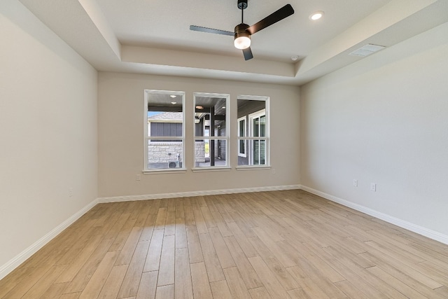 8508 Dongan Dr, Austin, TX 78744 - empty room featuring ceiling fan, a tray ceiling, light wood-type flooring, and recessed lighting