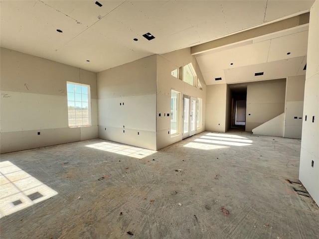 unfurnished room with a towering ceiling