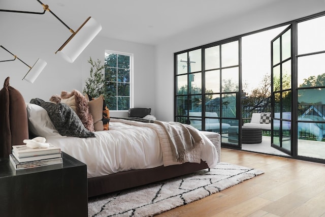 bedroom featuring light hardwood / wood-style flooring and access to outside